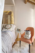 Armchairs with gifts next to the bed, headboard made from antique doors with fairy lights