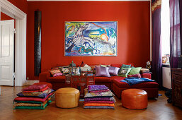Red living room with many cushions