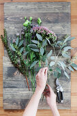Tying an autumn bouquet with eucalyptus and sedums