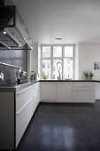 L-shaped kitchen with white cupboards