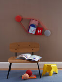 DIY-Wandregal, Stuhl mit Buch und Kinderhocker
