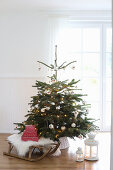 Christmas tree with Christmas decorations and antique sleigh