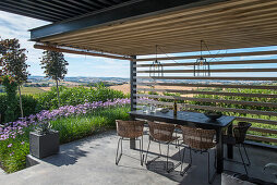 Sunny terrace with wooden pergola