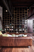 Leather couch and wall of shelves in a loft