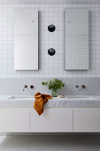 Double basins, white mosaic wall tiles provide the chic match to the Carrara marble vanity
