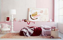 Bedroom in pink and white with wrapped Christmas presents