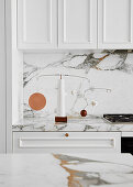Marble worktop and splashback in white kitchen
