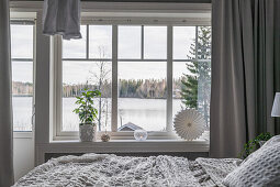 Double bed in bedroom with lake view