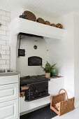 Old wood-burning stove in white kitchen