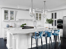 Kitchen island with Carrara marble worktop and bar stools with blue and white upholstery