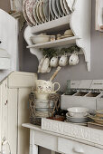 Old porcelain dinnerware in the kitchen in Shabby Chic Style