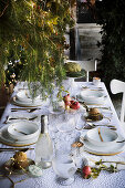 Festive Christmas table set with white tablecloth and gold accents