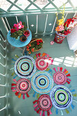 DIY patchwork rug made of colourful fabric scraps on balcony