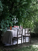 Set table with a lace tablecloth in the garden