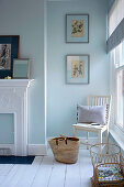 Chair in front of window in a light blue bedroom