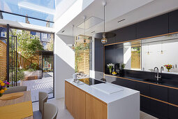 Modern open kitchen with skylight and garden access