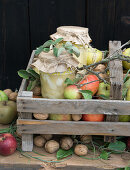 A wooden box of quinces, apples, walnuts and quince puree