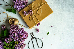 Spring gift box decorated with fresh lilac flowers