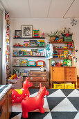 Shelves of colourful retro toys and bouncy animals in a children's room