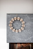 Wreath of honeycomb paper on fireplace wall