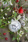 Christmas tree ornament of painted birds with mistletoe and bird seed