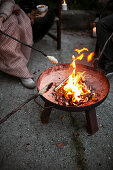 Barbecuing bread over a fire pit