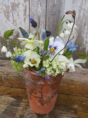 A flowerbouquet from the springgarden in a terracottapot