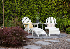 Adirondack chairs with ottomans on circular patio