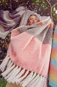Young woman with striped blankets (mohair and alpaca)
