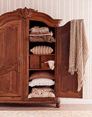 Antique French wardrobe with pillows and blankets