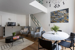 Open living room with dining area, staircase in the background in a maisonette flat