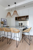 Open, bright kitchen with counter and bar stools
