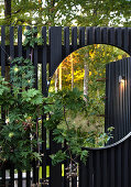 Fence with round mirror in garden
