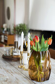 Bouquet of tulips in brown glass vase on a dining table