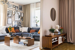 Corner sofa set with cushions and black and white photo collection on the wall in the living room