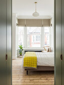 View into the bright bedroom with queen bed
