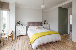 Double bed with capitoned bed head and nightstand in bedroom