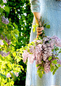 Woman holding bouquet of lilacs