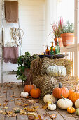 Straw bales and pumpkins on an autumnal veranda