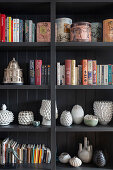 Black shelf with books and vases