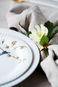 Christmas place setting with linen napkin and Christmas rose
