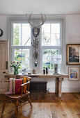 Antique oak workbench, above it Christmas decorations at the window