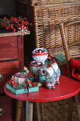 Christmas decoration with candles and gnome figurines on a red side table