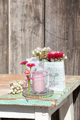 Lantern decorated with bellis and gift bags with spring bouquets
