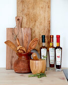 Wooden kitchen utensils and bottles of oil on kitchen worktop