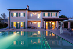 Illuminated villa with pool