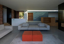 Upholstered furniture in a spacious living room with a concrete floor