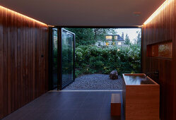 A spa area with wood panelling and indirect lighting