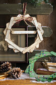 Christmas decoration made from wooden sticks, book pages and glittering stones