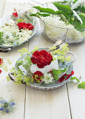 Bowl with red rose and elderflowers